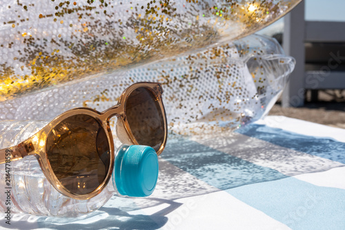 Sunglasses and water bottle for a summer beach vacation