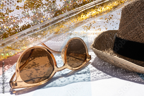 Sunglasses and sun hat creating a relaxed summer beach mood. Carefree holiday