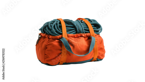 Orange rope bag containing coiled blue climbing cord isolated on white background with bright orange equipment filled thick coiled against clean white mountaineering