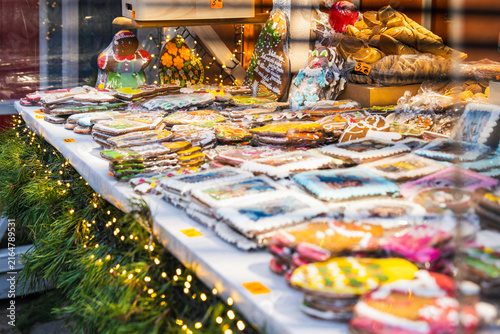 Photography Edible holiday artistry fills a brightly lit market table with decorated cookies, sweets and colorful packaged treats in Riga for festive baking, gift shopping and sensory detail