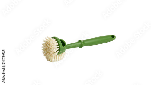 Green kitchen dish scrubber brush with stiff bristles for household cleaning with colored bristles isolated isolated against clean clean white background displays single green
