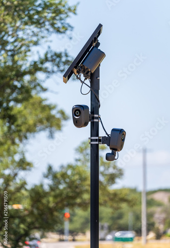 Solar powered automatic license plate reader camera installed on a suburban street pole for traffic monitoring near Georgetown Texas