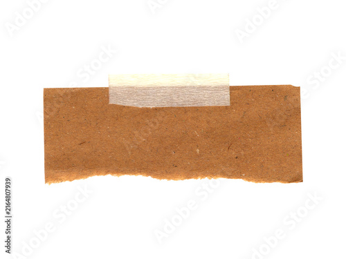 Small piece of brown textured cork board paper with a white tape strip