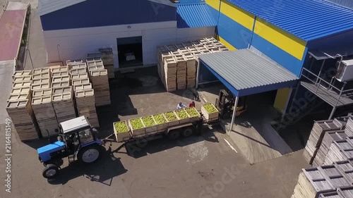 Drone circles apple unloading at warehouse