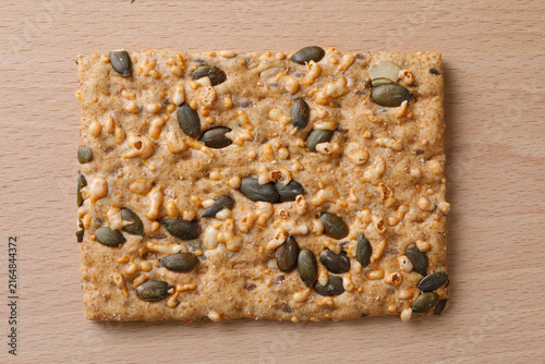 Crispbread  with pumpkin seed and cheese on wooden background