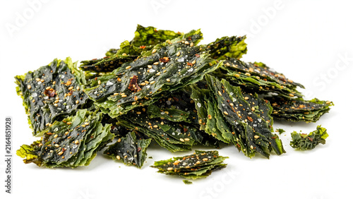A mountain pile of crispy green roasted seaweed snacks seasoned with white sesame seeds, sea salt crystals, and chili flakes sits on a white background.