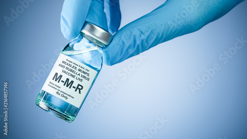 Canvastavla Nurses hand in blue medical gloves holding a vaccine bottle with MMR text