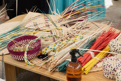 Фотография palm frond strips and woven basket with chevron pattern arranged with spray bottle for moisture