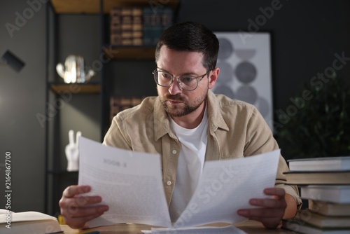 Quadro su tela Writer working on his book at desk in office