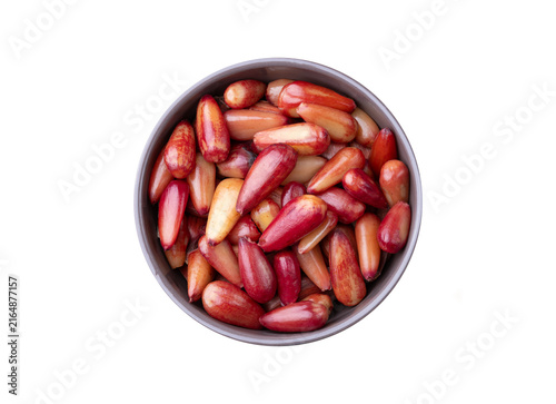 Cooked pinions or araucaria seeds on a bowl isolated over white background