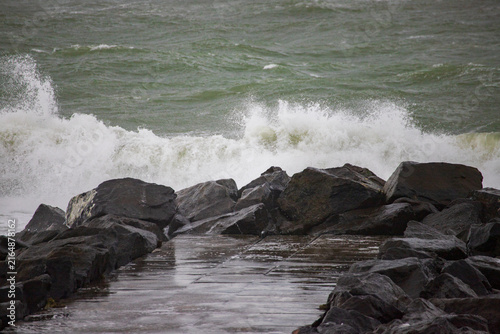 Принти на полотні Dramatic Storm Waves Breaking Over a Stone Sea Defense