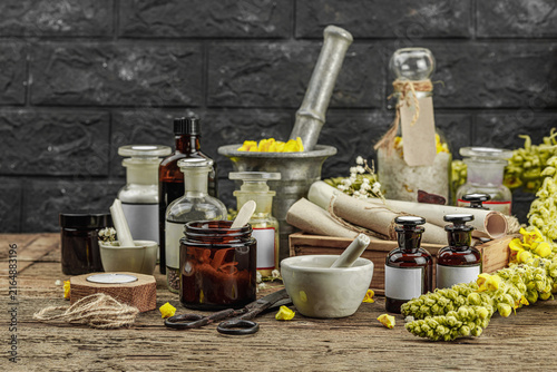 Rustic apothecary scene with Verbascum flowers, herbal jars, vintage tools and mortar