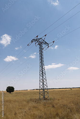 Konstfotografi Electricity pylon transmitting power lines across rural field
