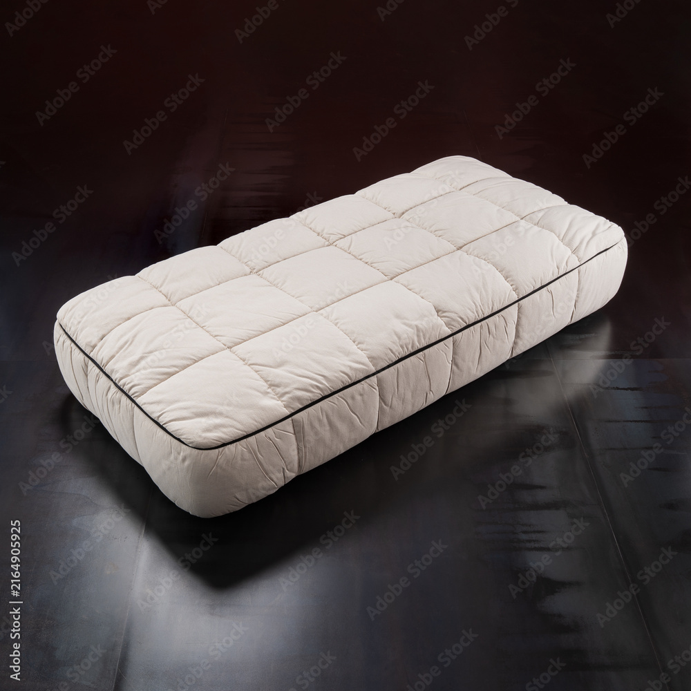 Naklejka premium designer single bed in quilted beige fabric.