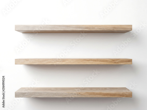 Three floating wooden shelves on white wall background