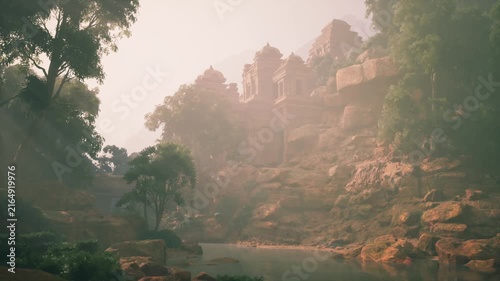 Mystical atmosphere envelops ancient temple ruins nestled among mountains. A serene river reflects the lush greenery, creating a peaceful sanctuary for exploration and reflection.