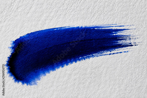 Blue watercolor paint stroke isolated on white textured paper background