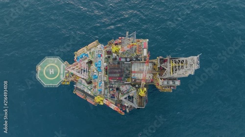 Offshore drilling rig - jack up and offshore platform during sunset for oil and gas exploration and production. 