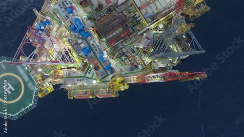 Offshore drilling rig - jack up and offshore platform during sunset for oil and gas exploration and production. 