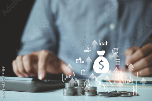 Obraz na plátně Businessman is calculating income and return on investment in percentage