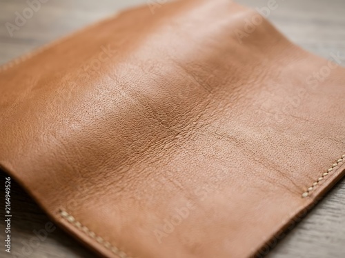Macro detail of smooth tan leather texture with material background stitched accessory handmade