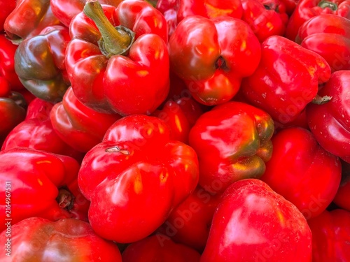 Quadro su tela A glossy pile of ripe red bell peppers, fresh and vibrant at the market, with a