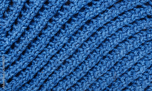 фотографія Detailed texture of a navy blue knitted garment, thick wool threads interlaced i