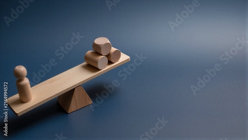 Wooden seesaw balances a figure and cylinders, symbolizing weighty decisions.