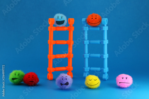 Obraz na plátně Happy climbing the opposing team's ladder surrounded by the work teams