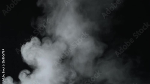 Thick white smoke swirls and billows against a dark black background, creating a dramatic abstract effect.