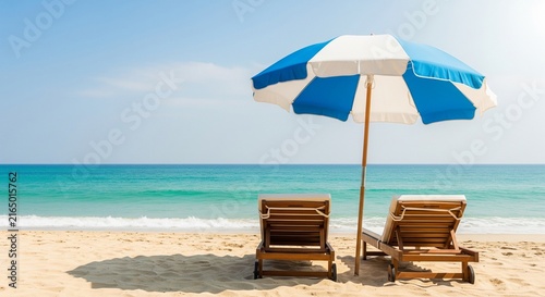 Relaxing beach lounging under blue umbrella with ocean views and sun chairs