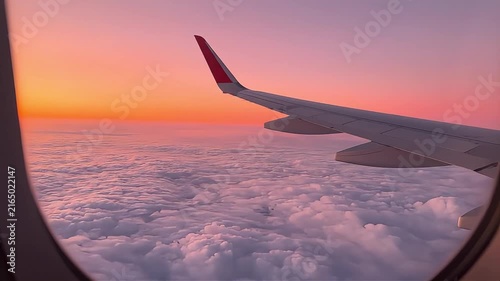 Airplane Wing over Vibrant Clouds During a Beautiful Sunset Flight