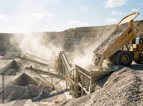 Haul truck tipping rock at a quarry crushing plant