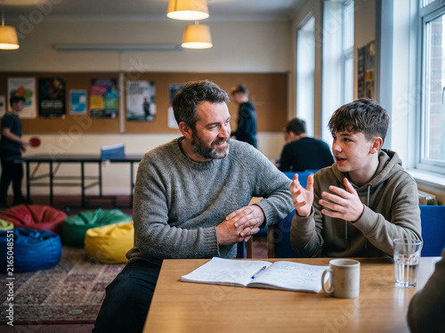 Mentor coaching a teenager at an after school club