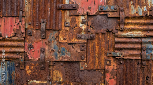 Rusty Weathered Metal Wall with Peeling Paint and Bolts Full Frame