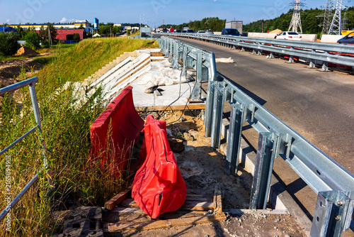 Obraz na plátně Bright orange safety barriers sit beside a highway road construction zone with m