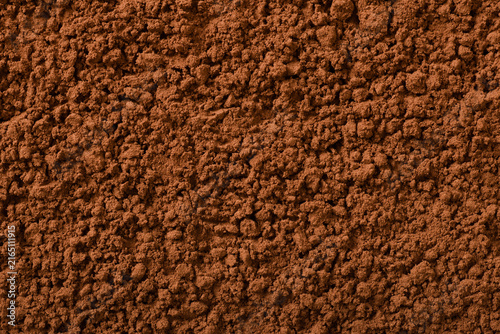 Food background of raw cocoa powder, top view.