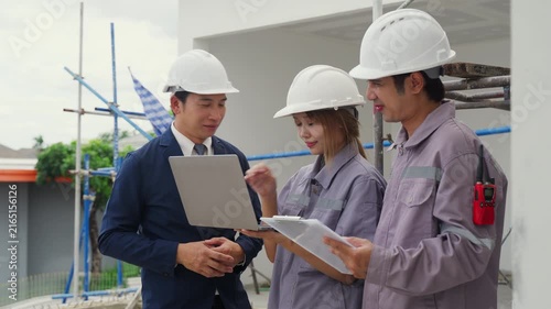 Construction inspector safety helmet laptop clipboard teamwork discussion building site engineer professional planning architecture project outdoor business worker industry meeting blueprint