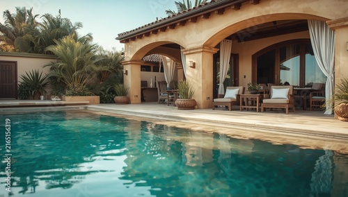 Luxurious villa with an inviting pool surrounded by lush greenery and elegant decor during sunny weather