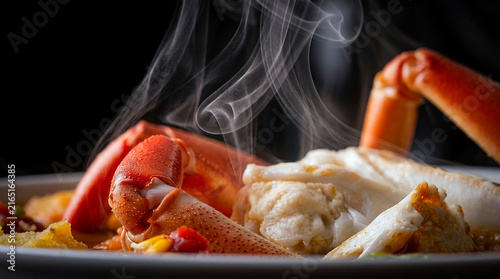 Steaming hot seafood broth featuring large red crab legs served in a white bowl for Crab Soup Day gourmet meal celebration close up shot