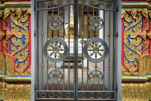 Canvastavla Ornate Metal Gate with Dharma Wheel Motifs and Gold Stucco Decoration at Thai Bu