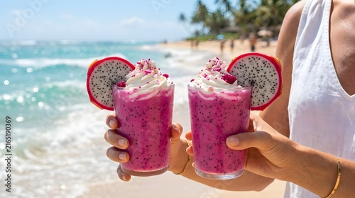 Two pink dragon fruit smoothies with whipped cream at the tropical beach pink smoothie sea waves