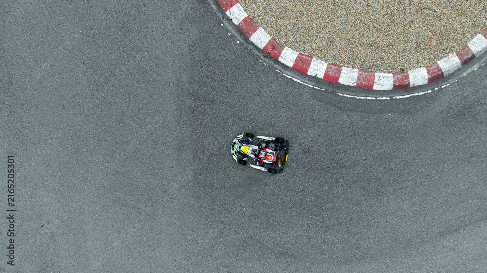 Fototapeta premium Aerial view go kart racer race curve circuit, Go kart at circuit curve, Top view race go kart track curve.