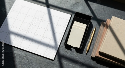 Blank Monthly Calendar Planner with Notebooks and Pen on Slate Desk