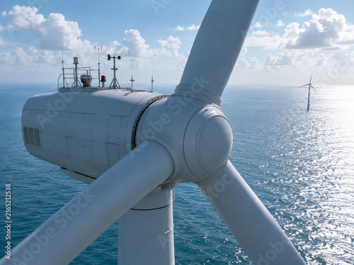 Aerial Close-Up of Offshore Wind Turbine Generating Renewable Energy Over the Ocean