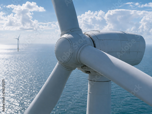 Aerial Close-Up of Offshore Wind Turbine Generating Renewable Energy Over the Ocean