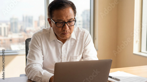 thoughtful focused Asian businessman with distinct facial features