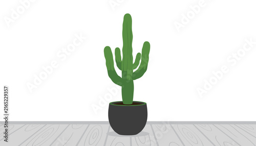 Green cactus in a dark grey pot stands on a light wooden floorboards surface against a solid white wall in a bright indoor room setting.