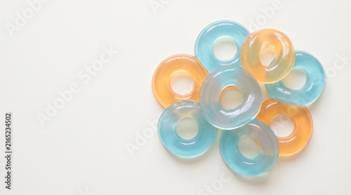 Squishy jelly rings cluster in blue and orange colors on white background with soft light and smooth texture