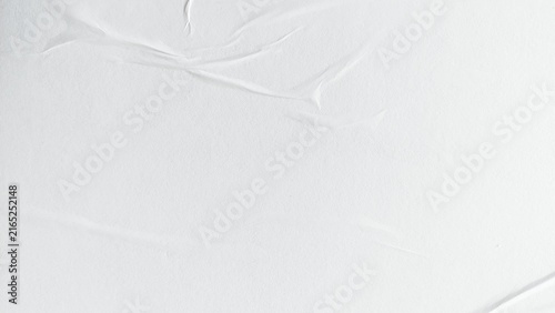 White paper poster abstract background with crumpled and creased surface texture. Blank white poster paper with soft wrinkled texture. Crushed white paper poster background with creased surface.